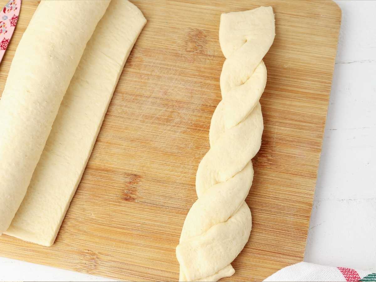 Braided bread on a cutting board.