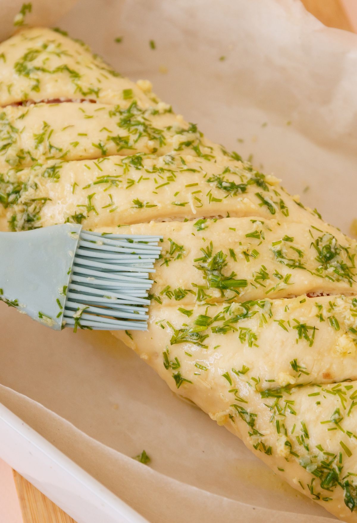 BUTTER AND HERBS ON PIZZA DOUGH.