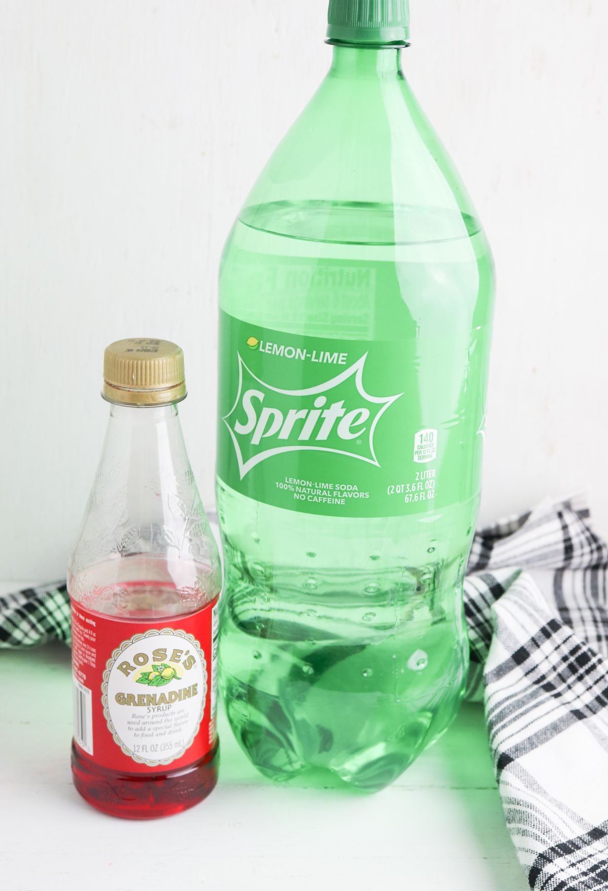 A bottle of sprite and a bottle of GRENADINE.