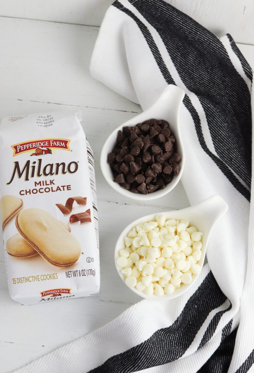 A bowl of chocolate chips and a package of milano chocolate chips.