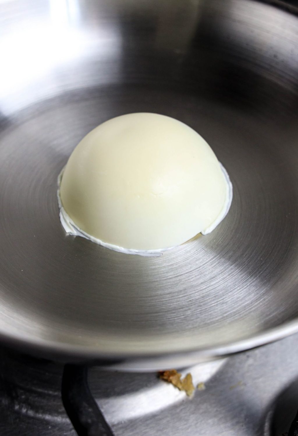 An egg is being cooked in a frying pan.