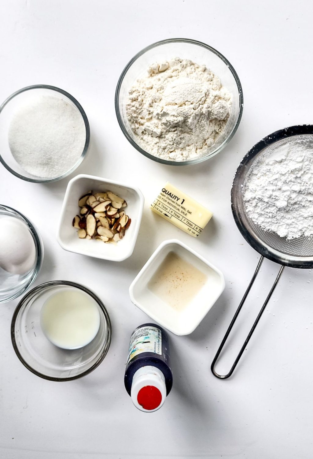 The ingredients for a cookie recipe are laid out on a white surface.