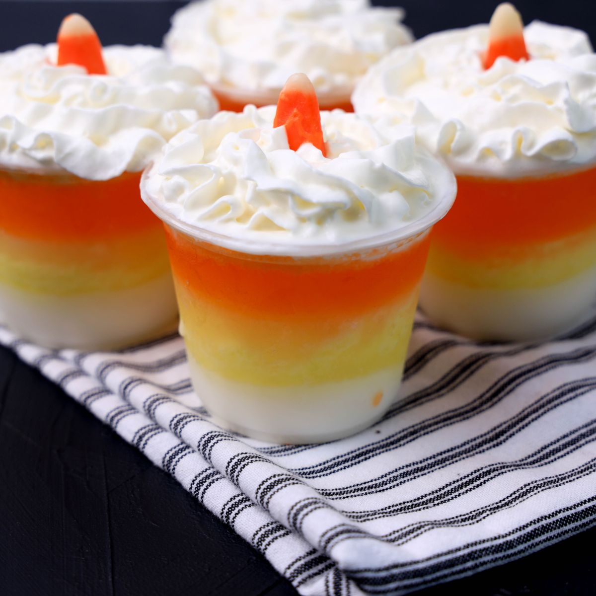 Candy corn jello cups with whipped cream.
