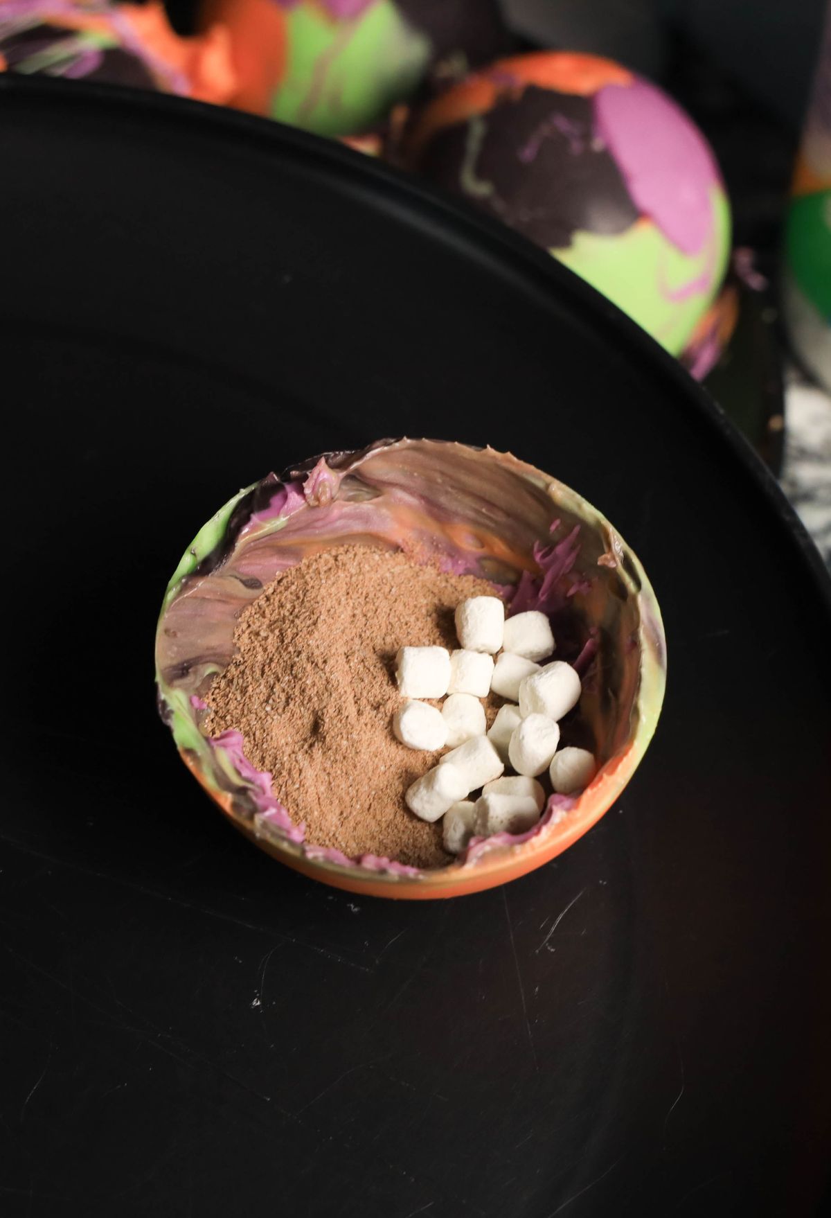 A bowl filled with marshmallows and powder.