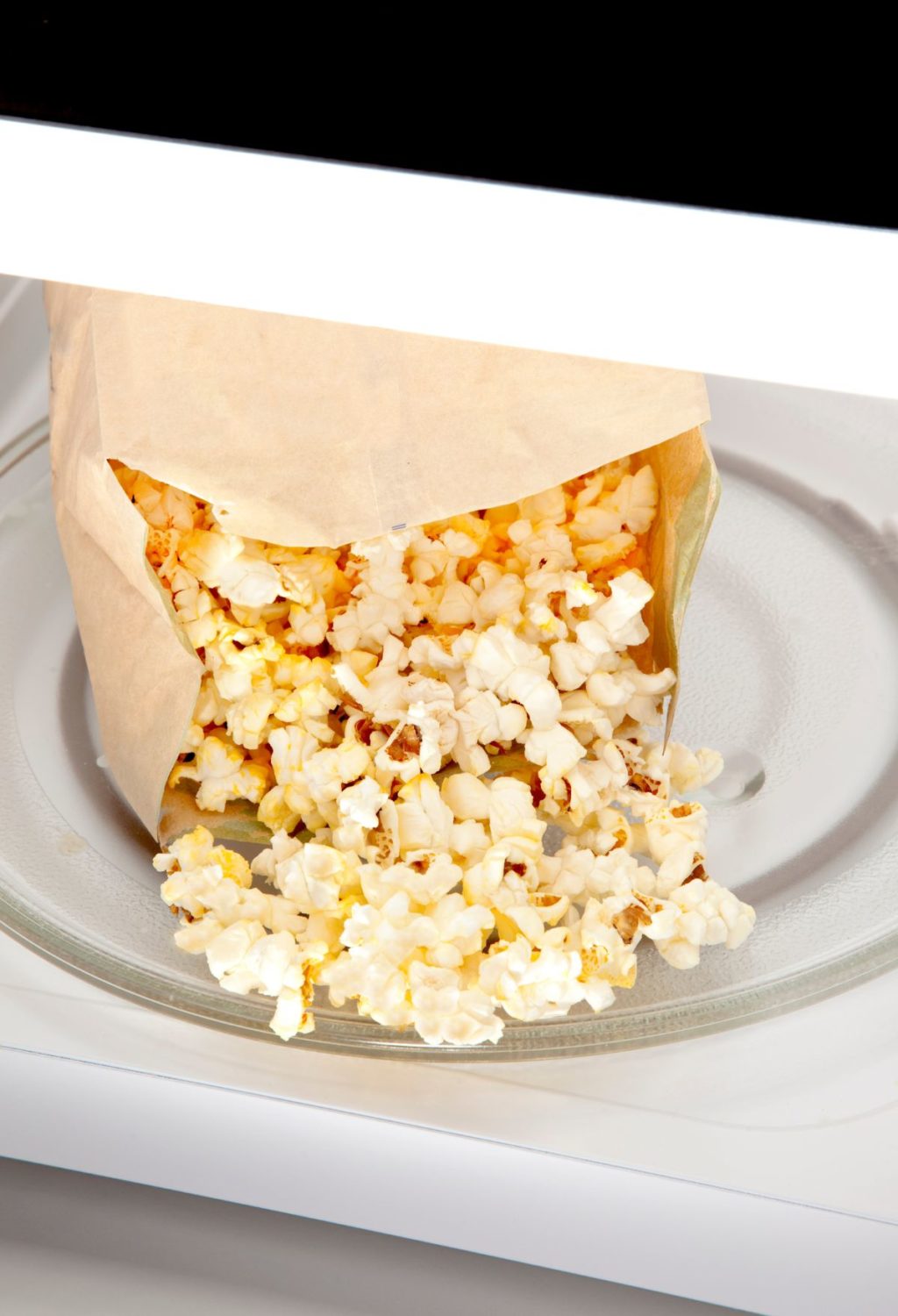 A bag of popcorn in a microwave.