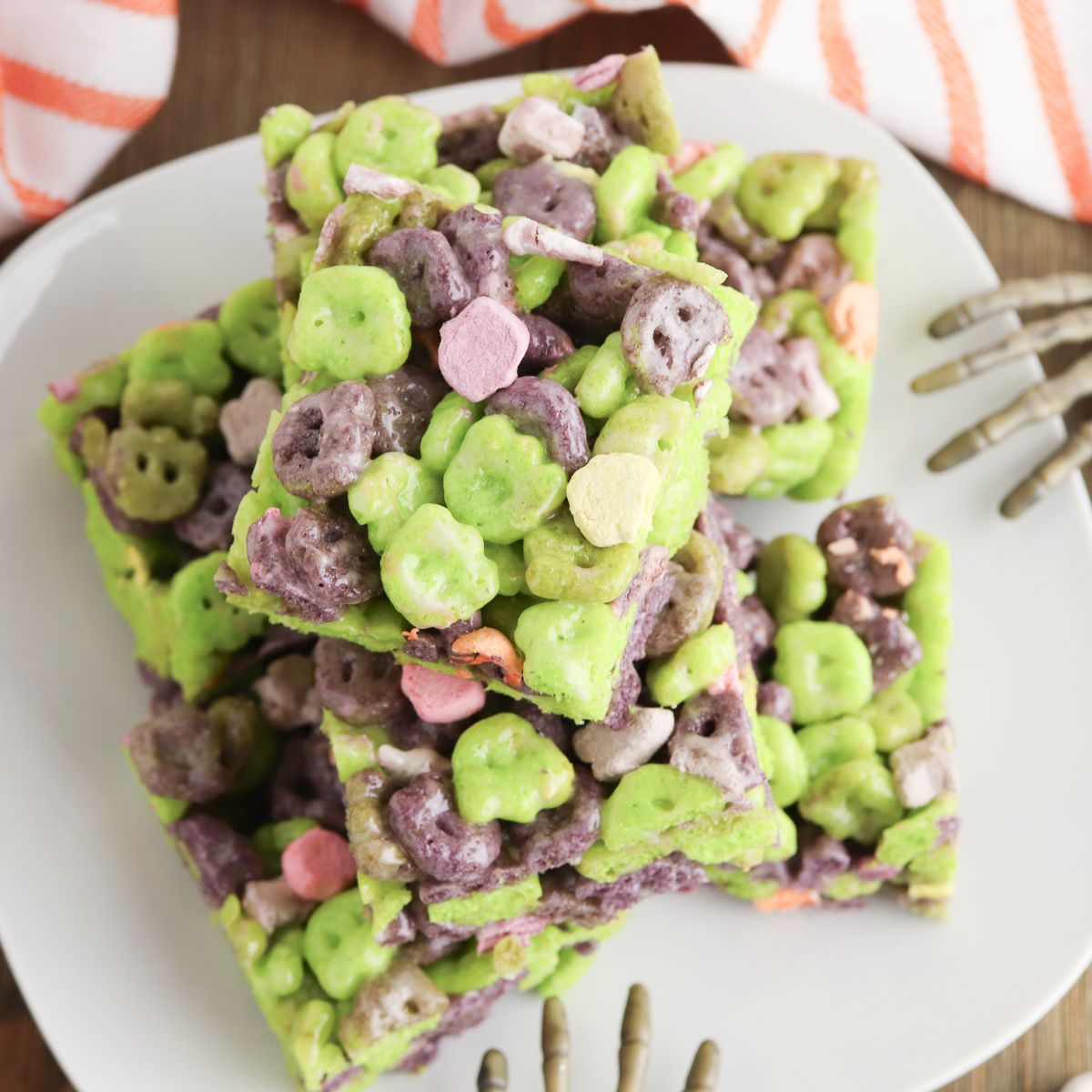 A plate of green and purple cereal bars on a white plate.