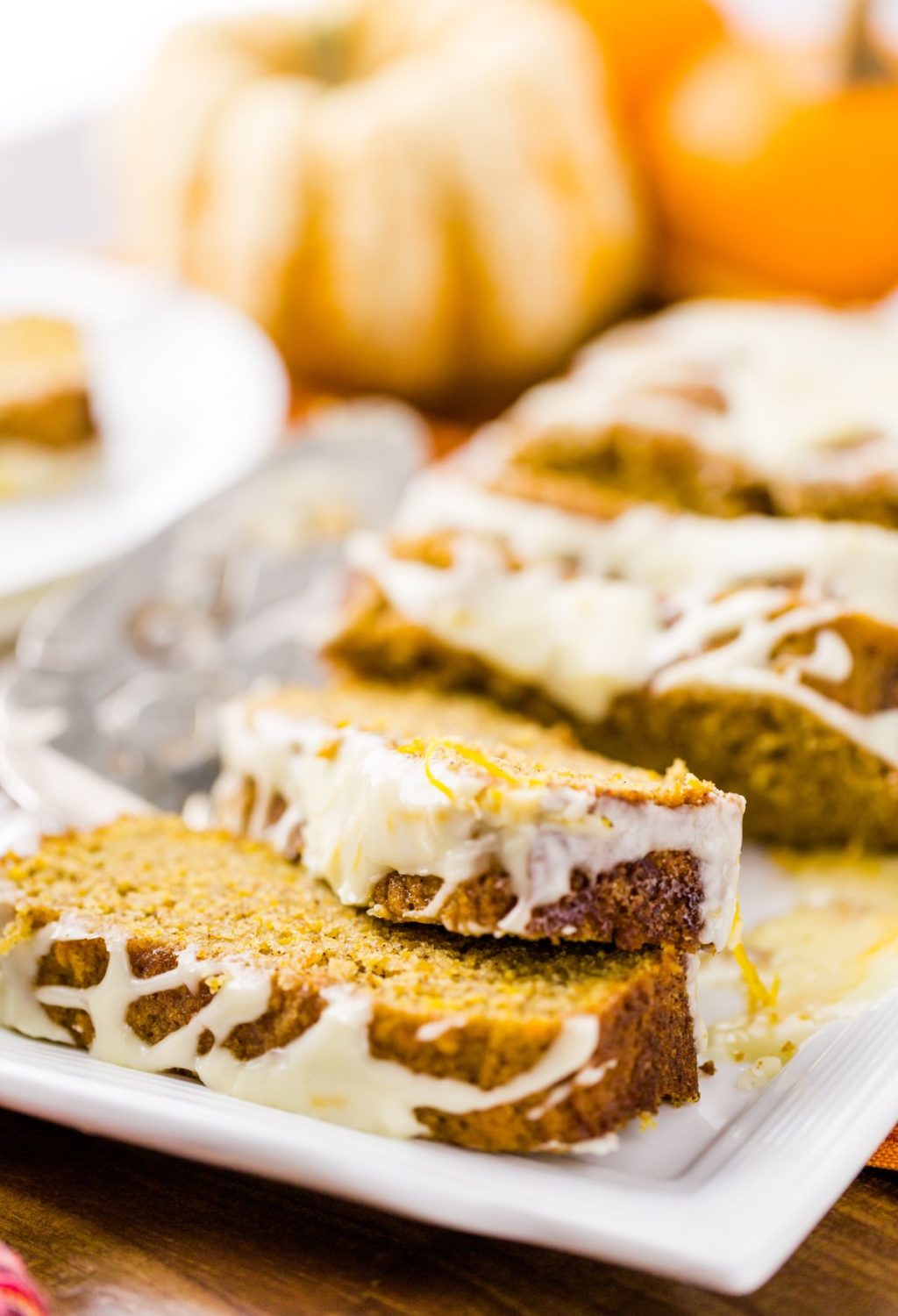 A slice of pumpkin bread on a white plate.
