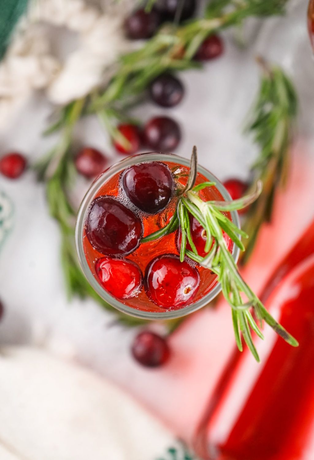 Cranberry juice with sprigs of rosemary.