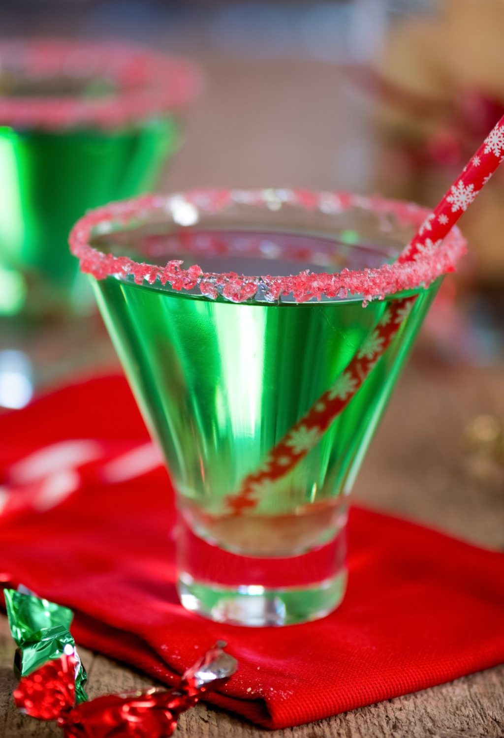 Two green martinis on a red napkin.