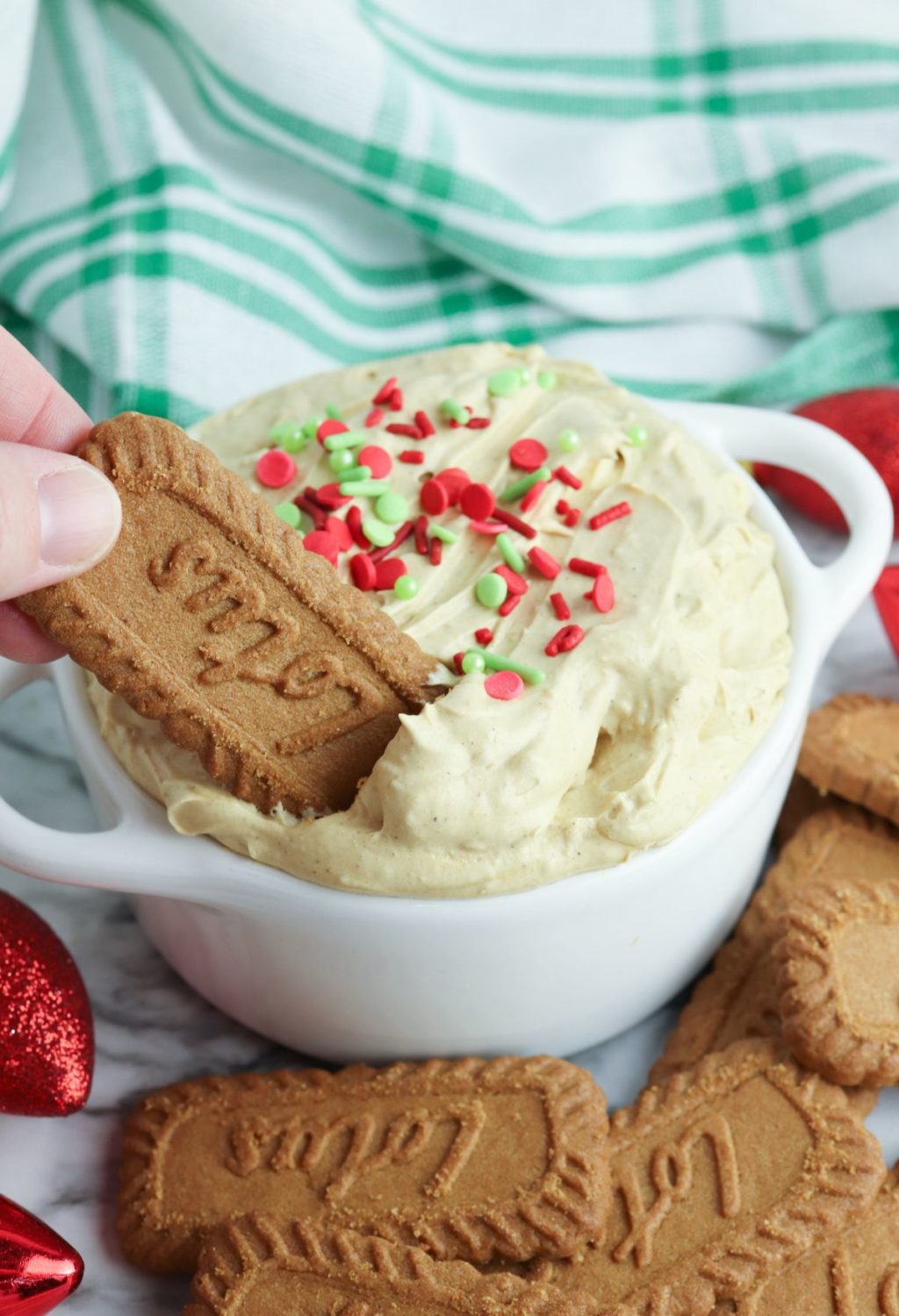 A person holding a bowl of gingerbread cookie dip.