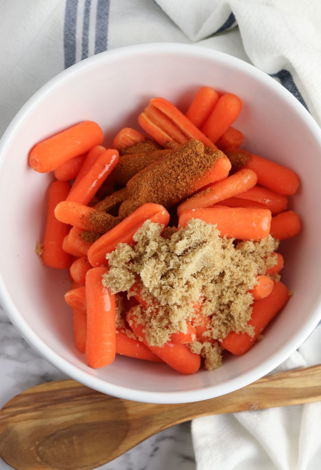 Carrots in a bowl with cinnamon and sugar.