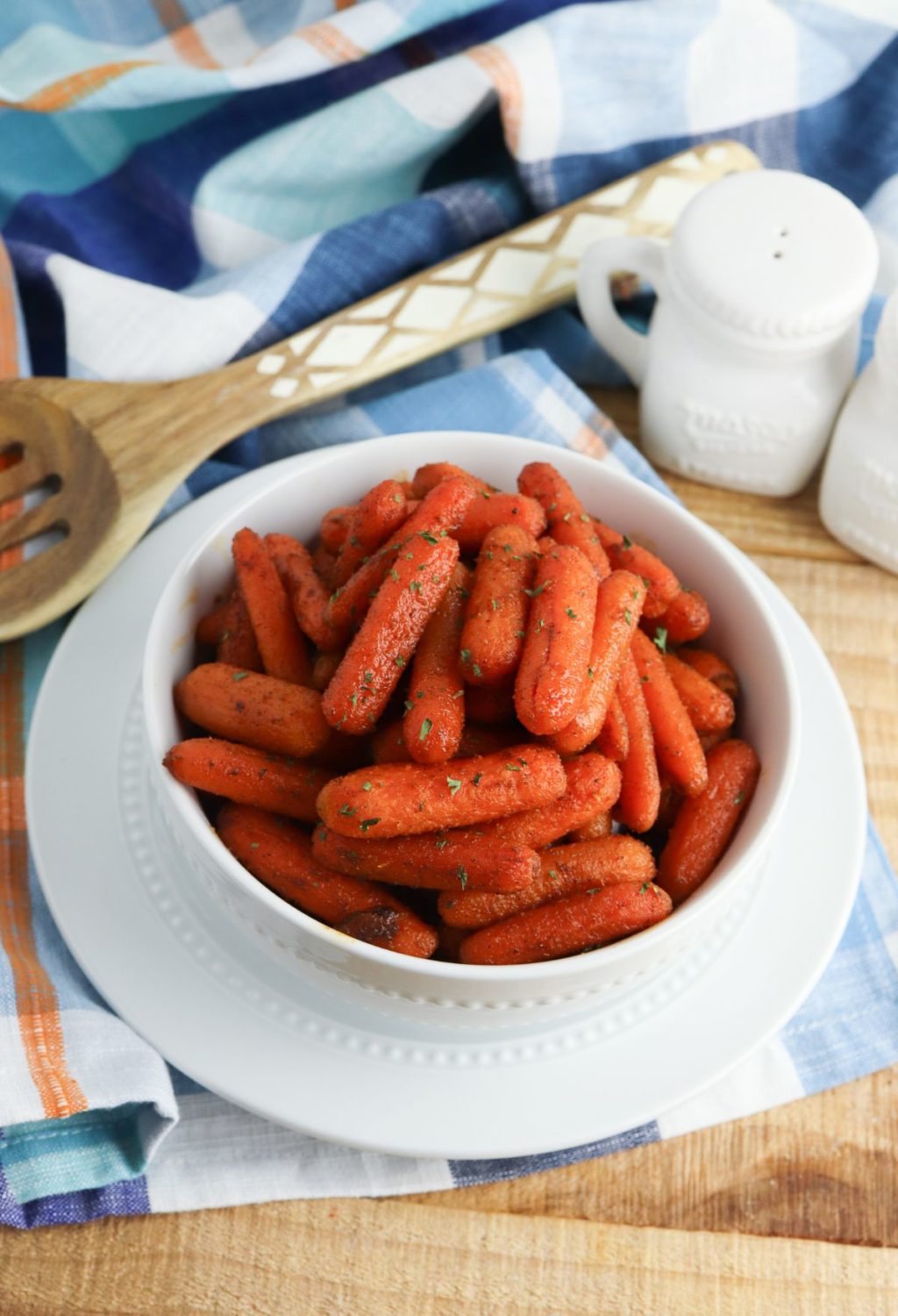 Roasted carrots in a white bowl on a table.