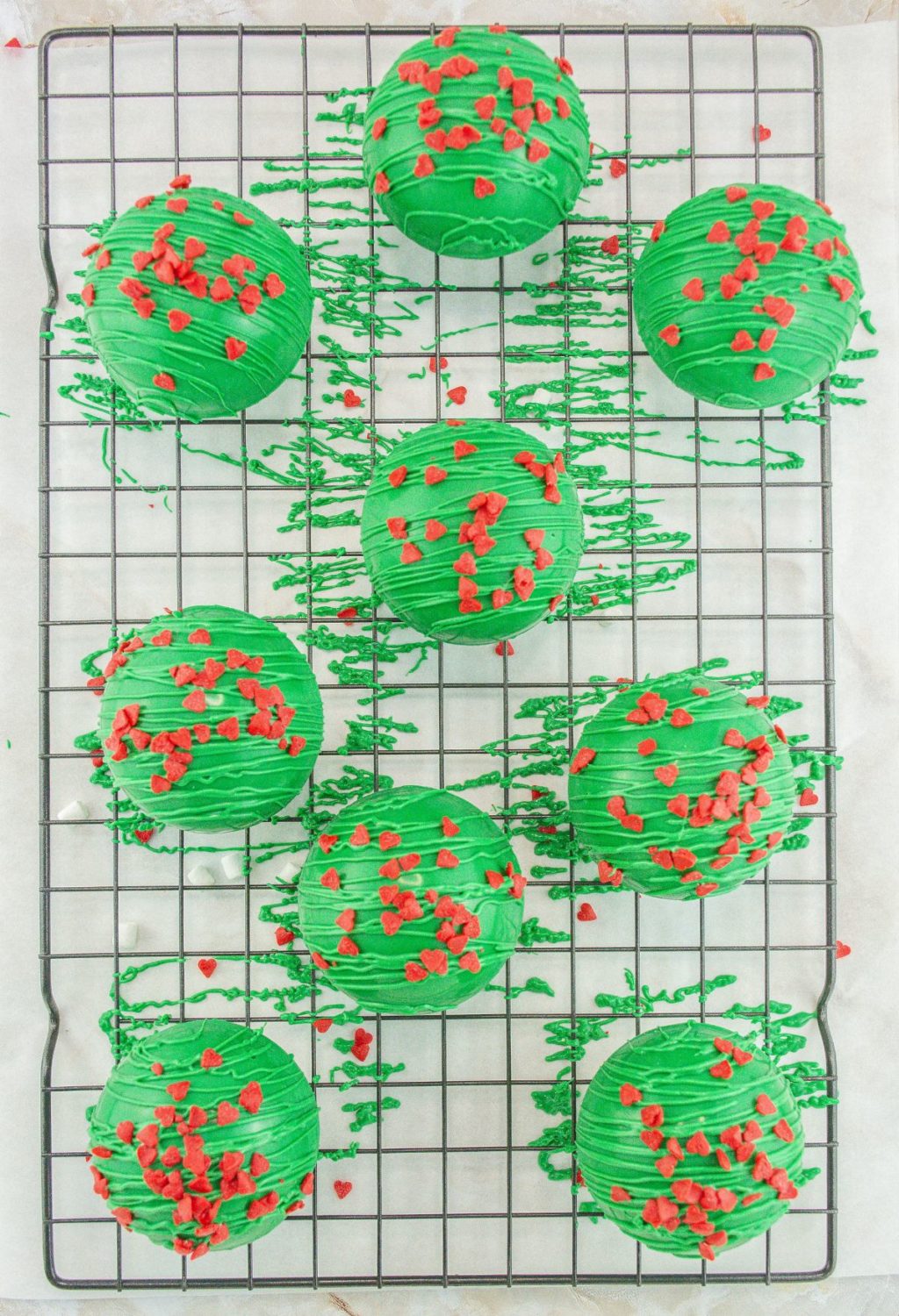 Christmas cookies on a cooling rack with red and green sprinkles.