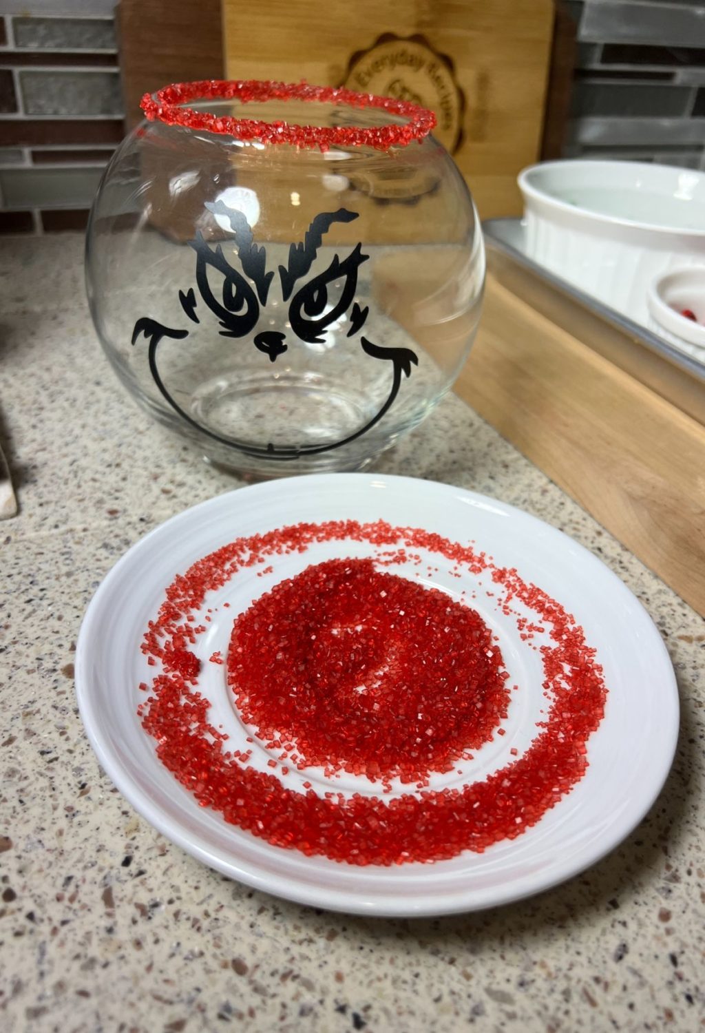 A plate with red sprinkles on it next to a bowl.