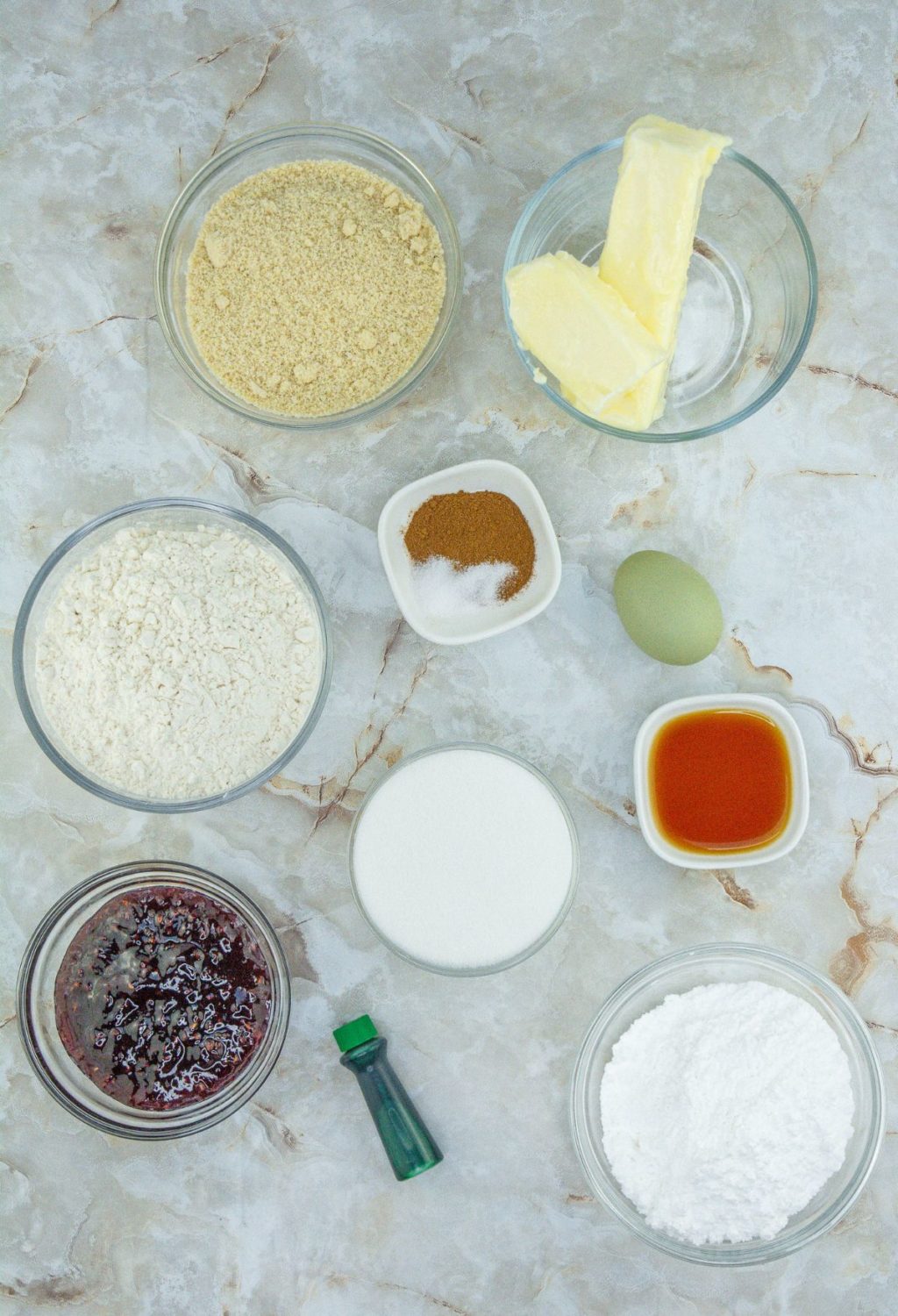 The ingredients for a cake are shown on a marble table.