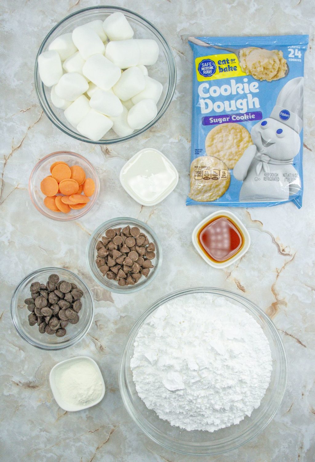 Marshmallow cookie dough ingredients on a marble countertop.
