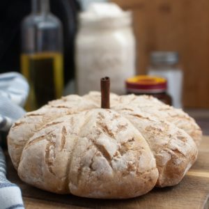 A loaf of bread sitting on a cutting board.
