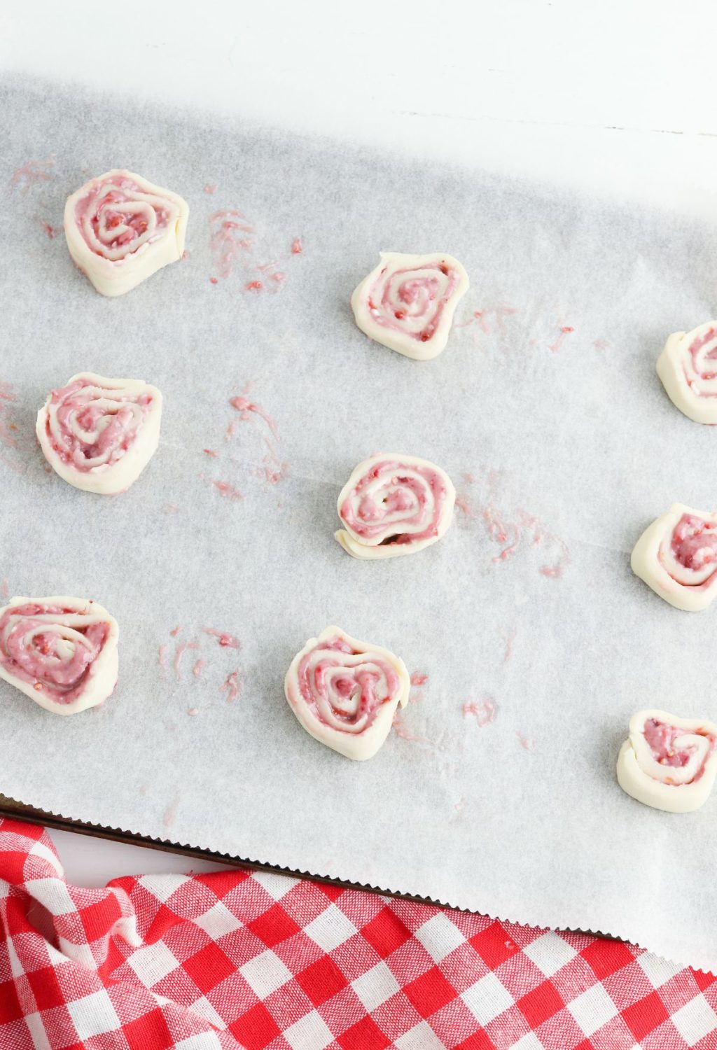 A baking sheet with red and white roses on it.