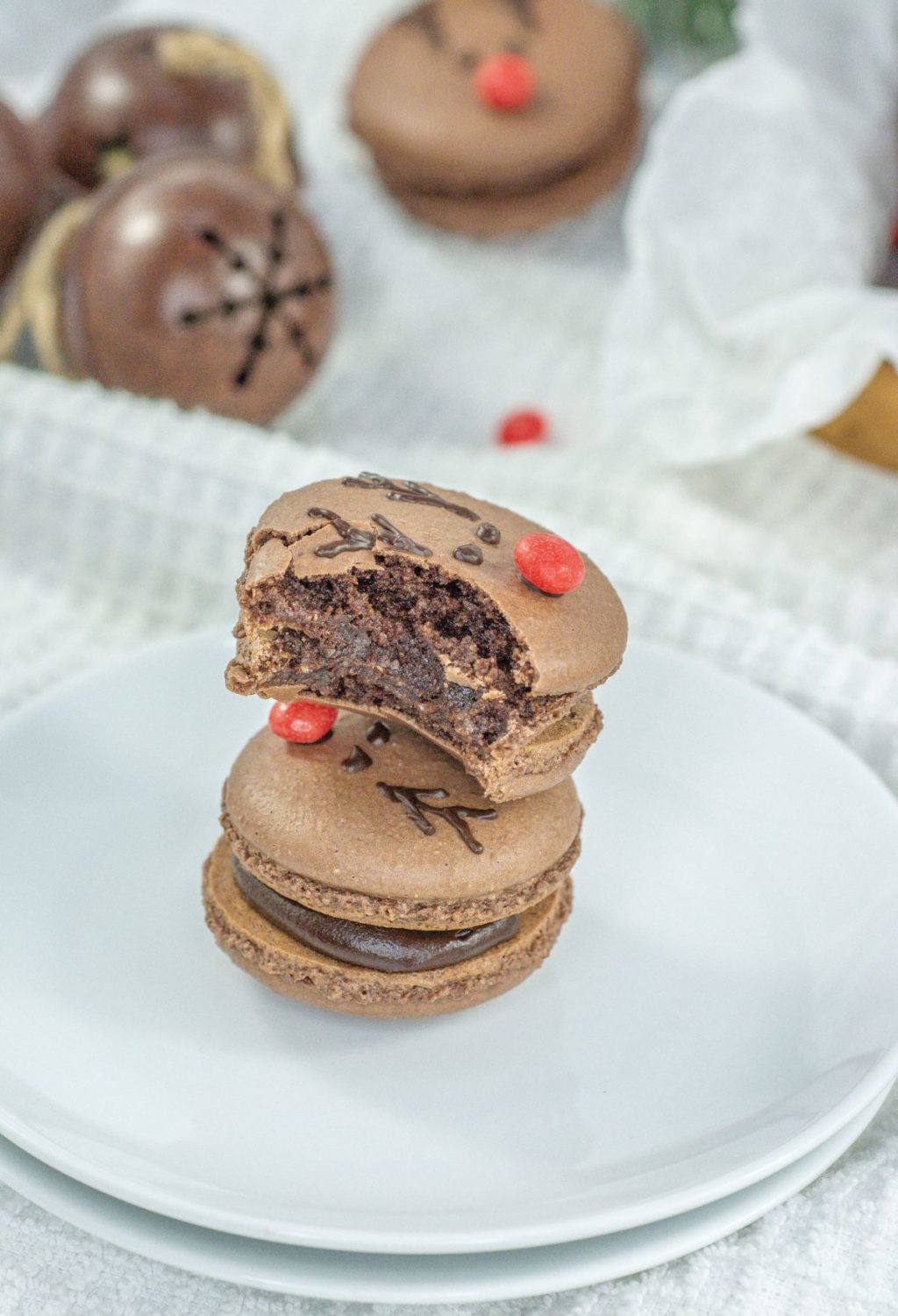 Two chocolate macarons stacked on top of each other.