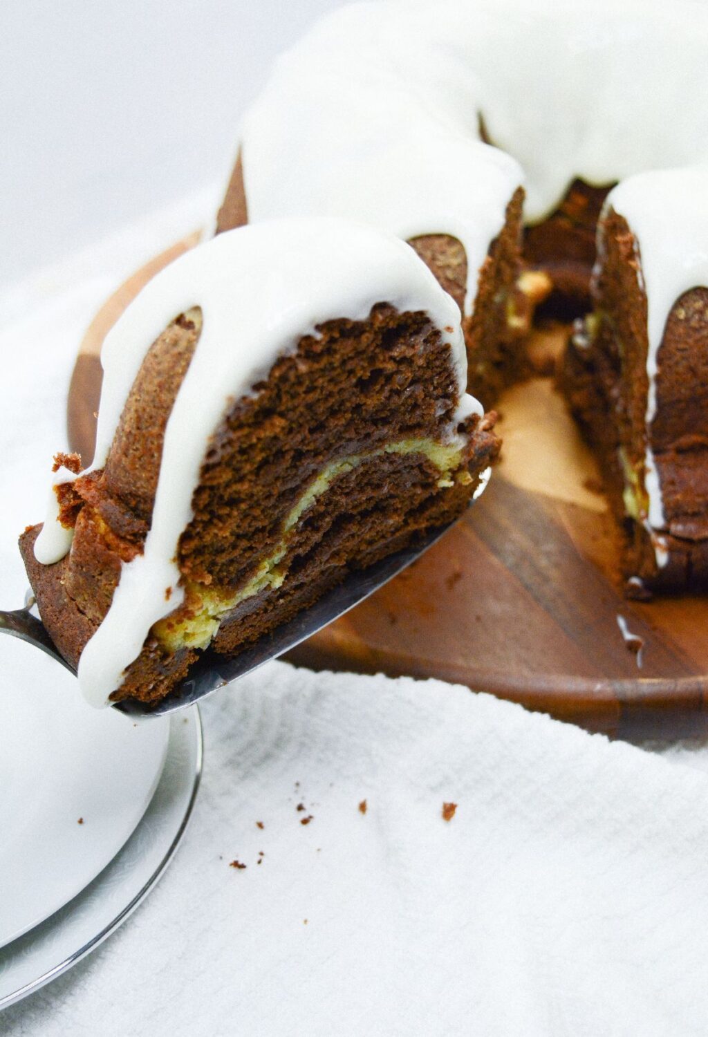 A chocolate bundt cake with icing on top.