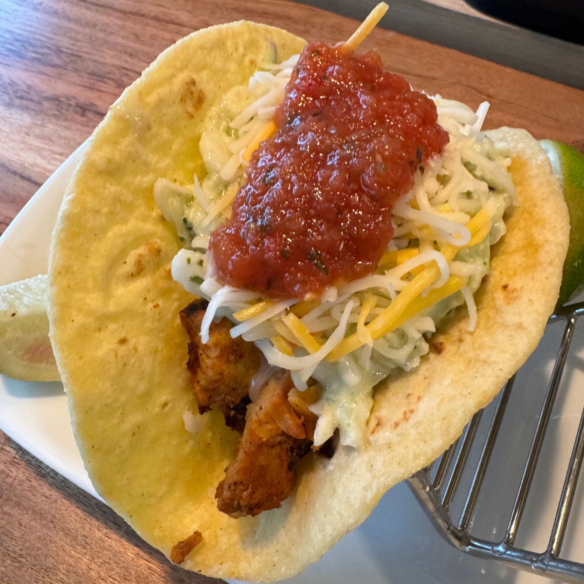 A taco sits on top of a plate.