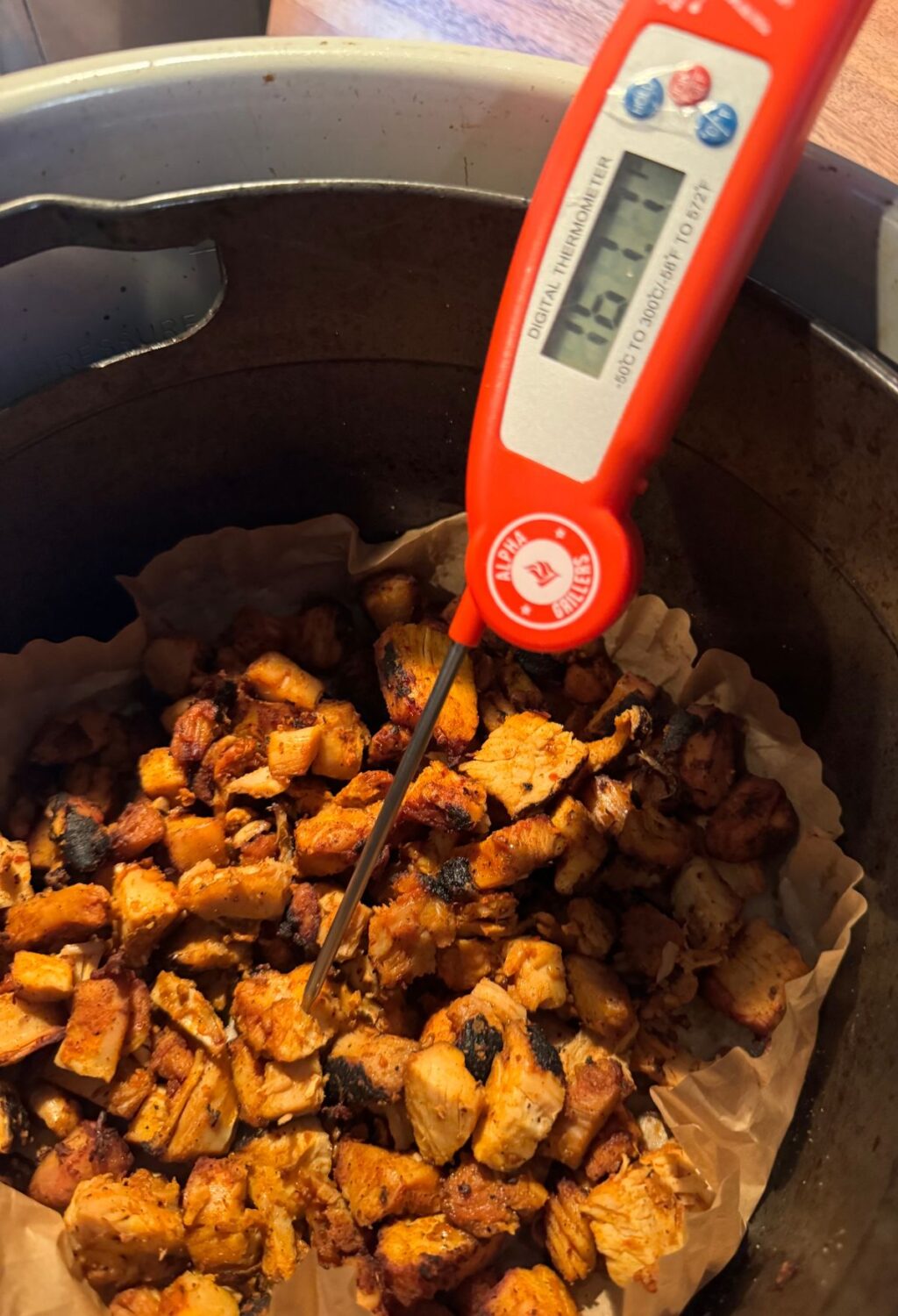A thermometer is being used to check the temperature of some food.