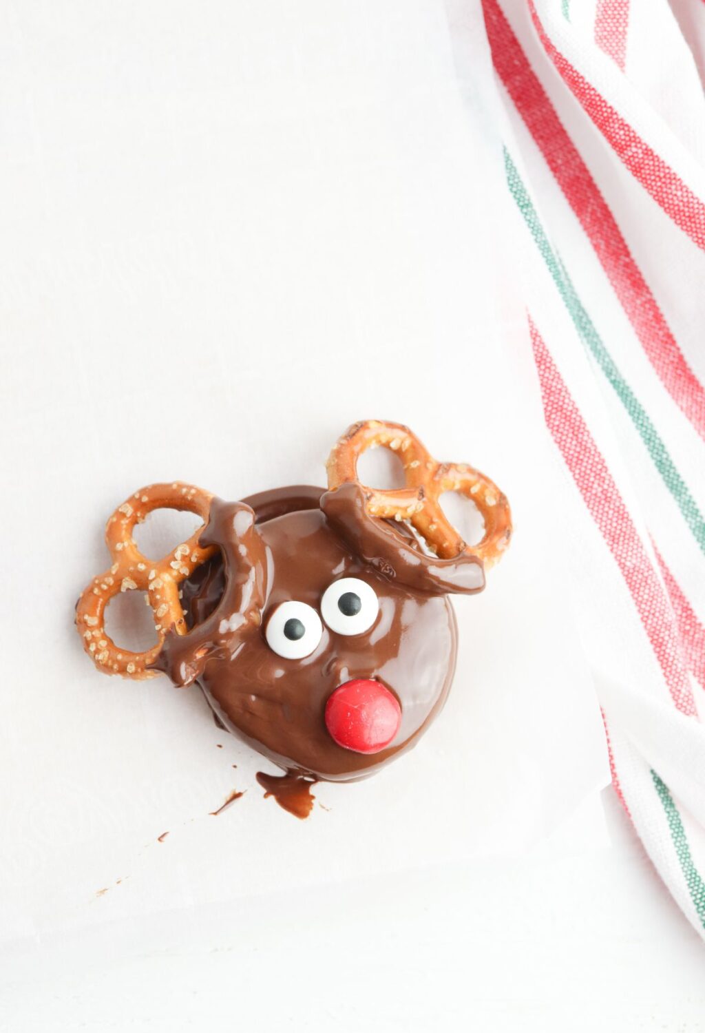 Chocolate reindeer pretzels on a napkin.