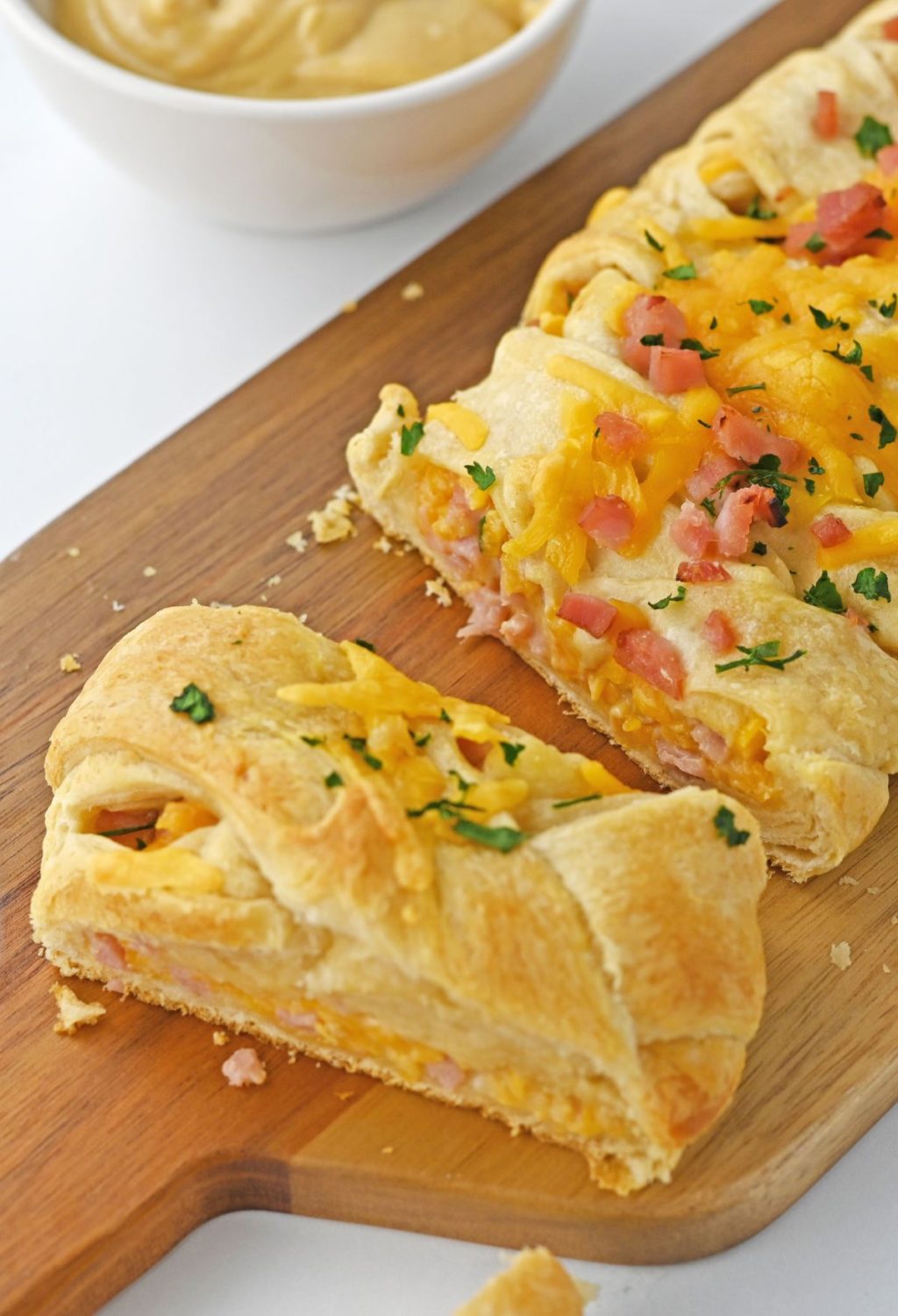 Ham and cheese crescent rolls on a cutting board.