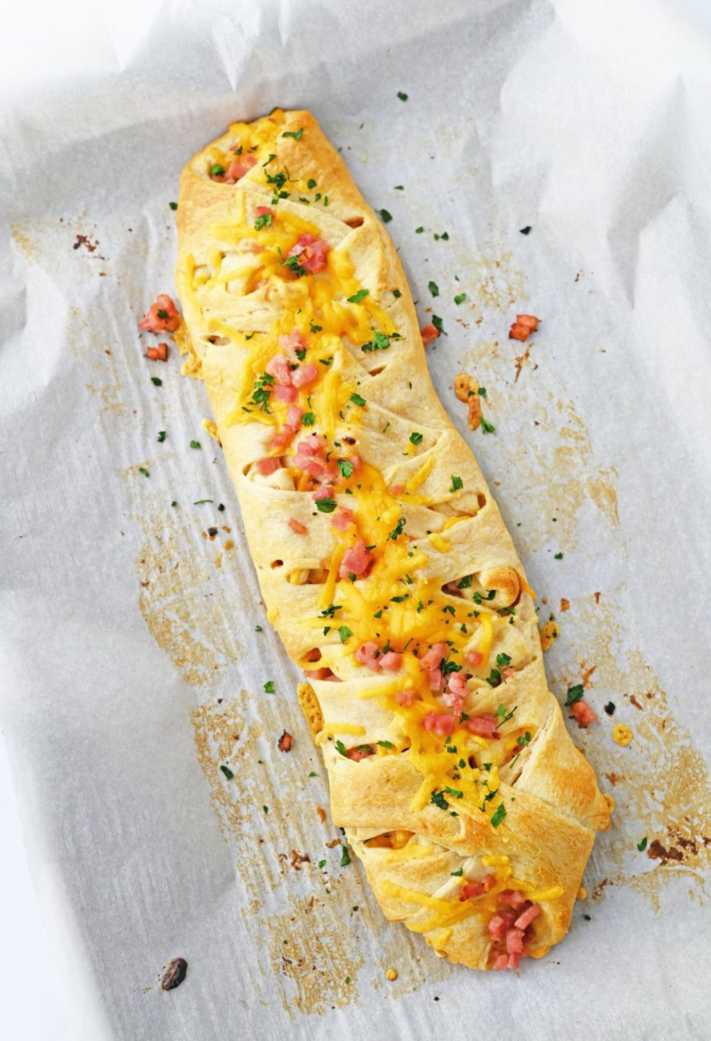 A long bread with cheese and meat on it.