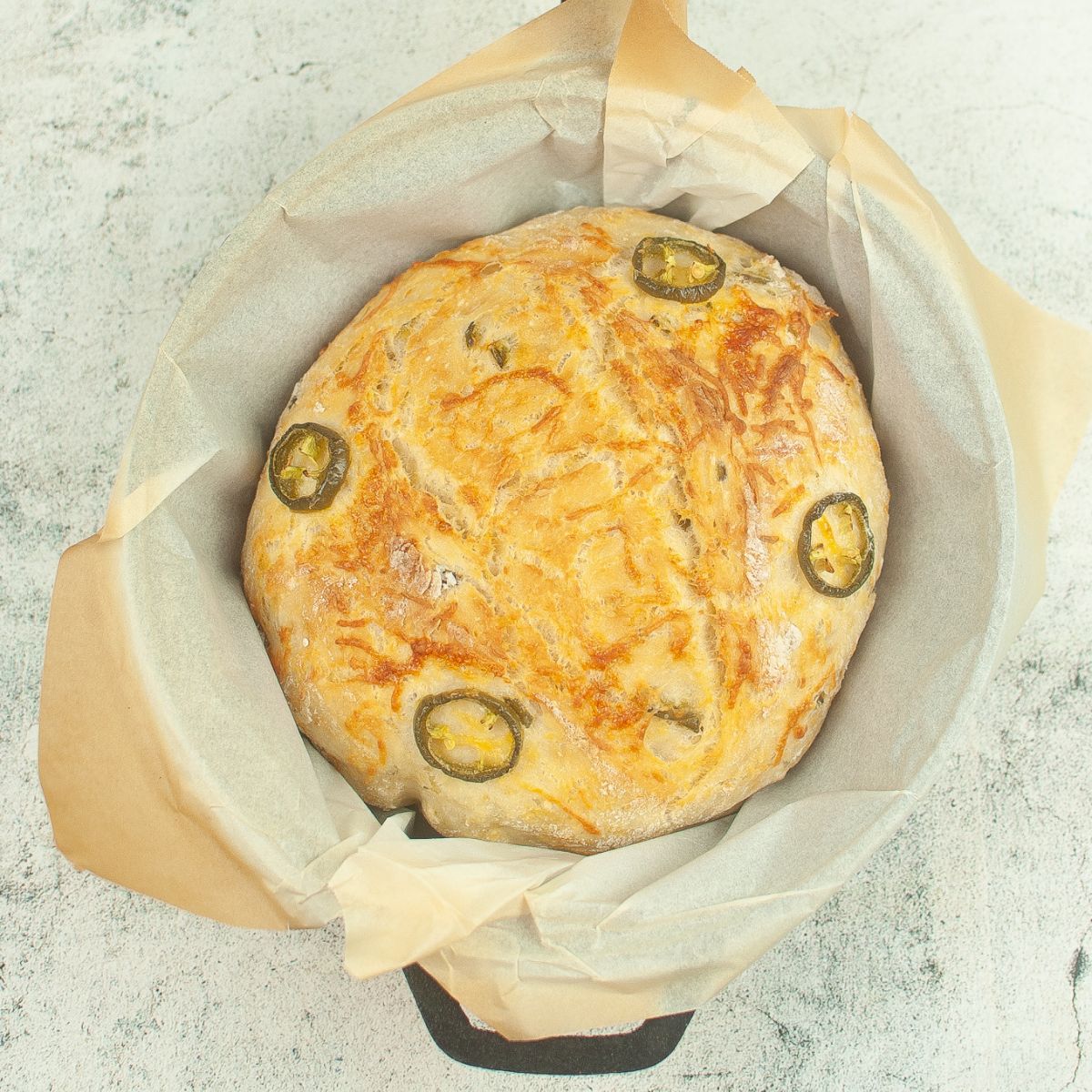 A loaf of bread with jalapenos in it.