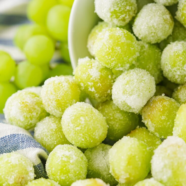 A bowl of grapes covered in sugar.
