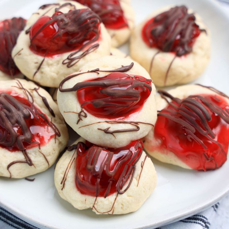 A plate of cookies with red and white icing.