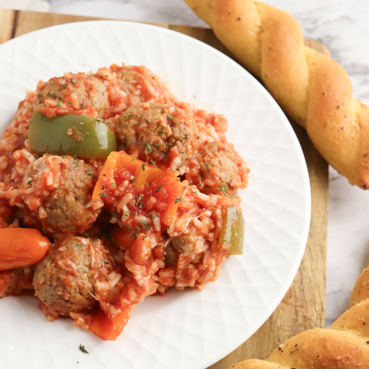 A plate with meatballs and vegetables on it.