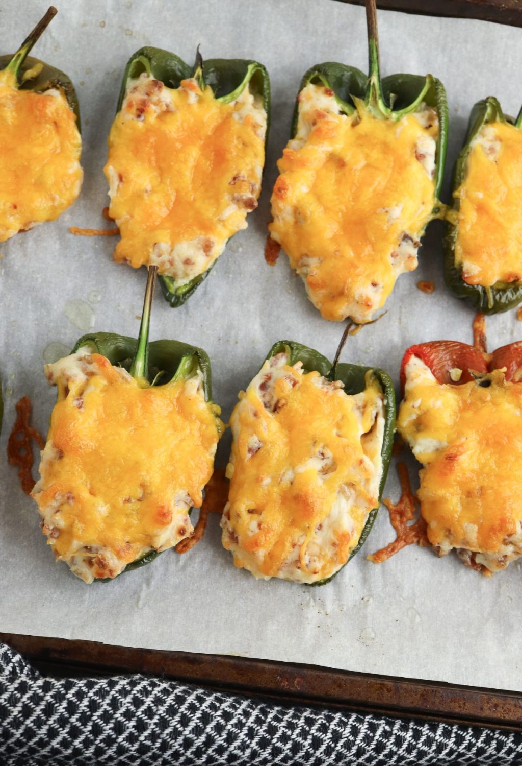 A group of stuffed peppers with cheese.
