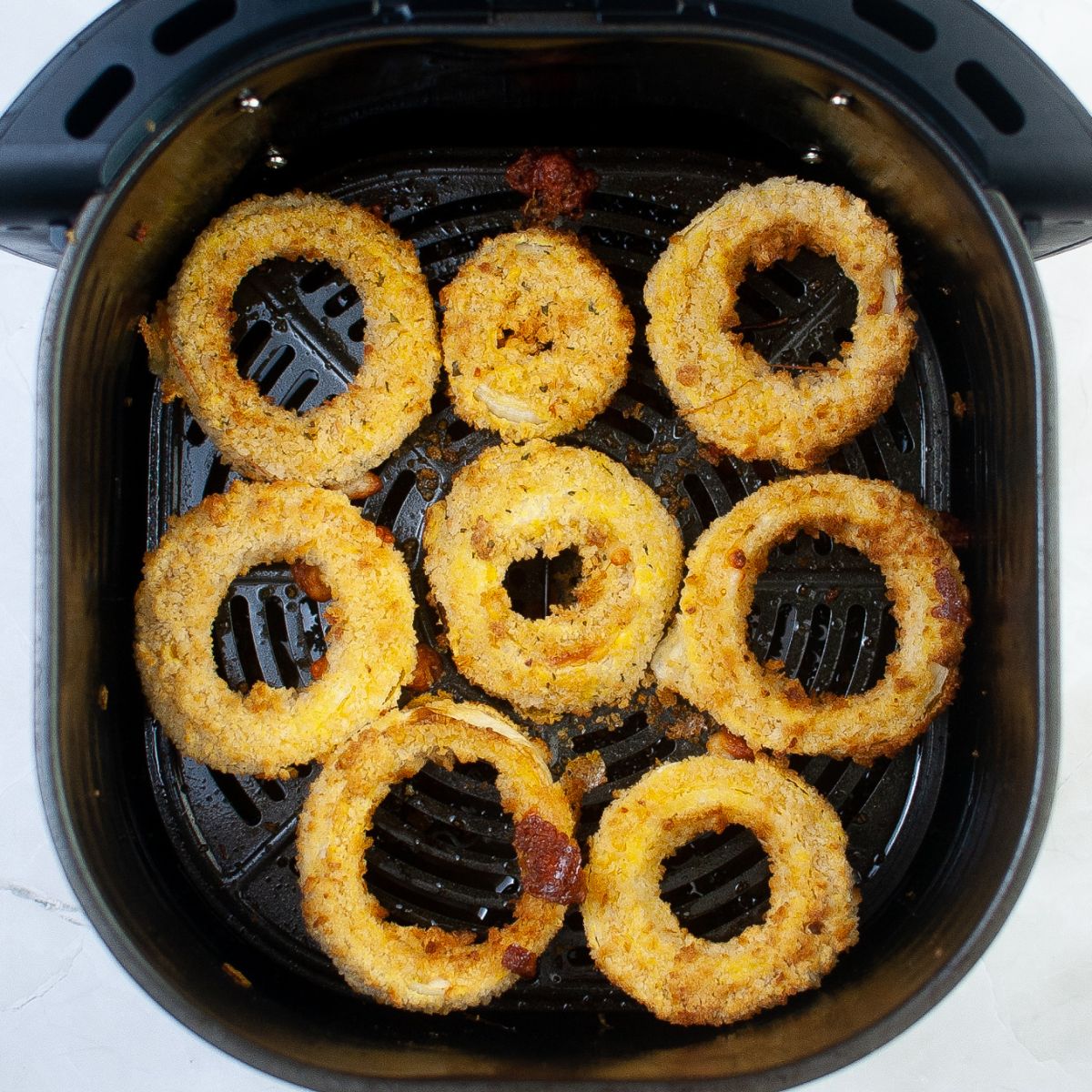 Fried onion rings in an air fryer.