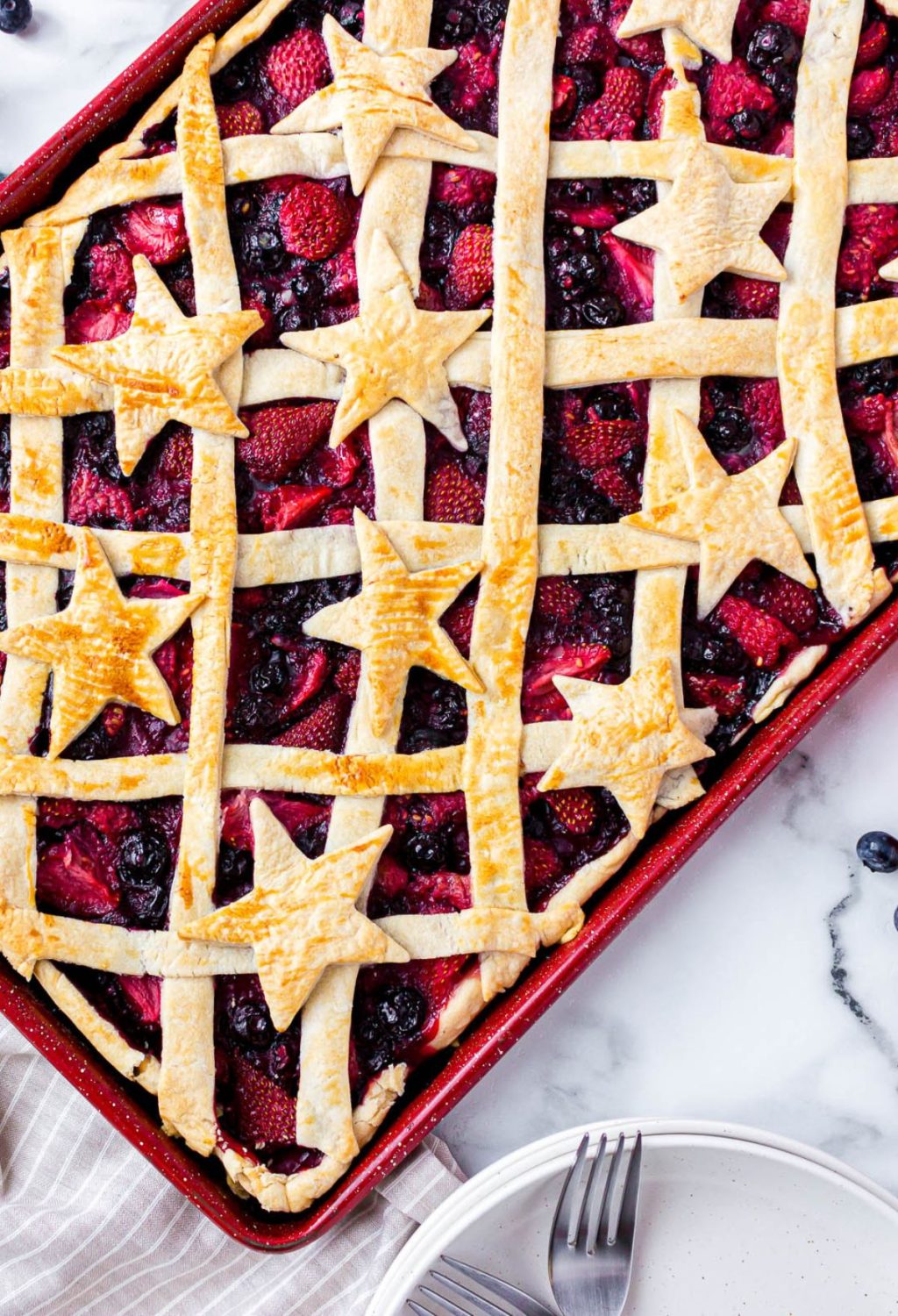 Patriotic berry pie in a pan with stars on top.