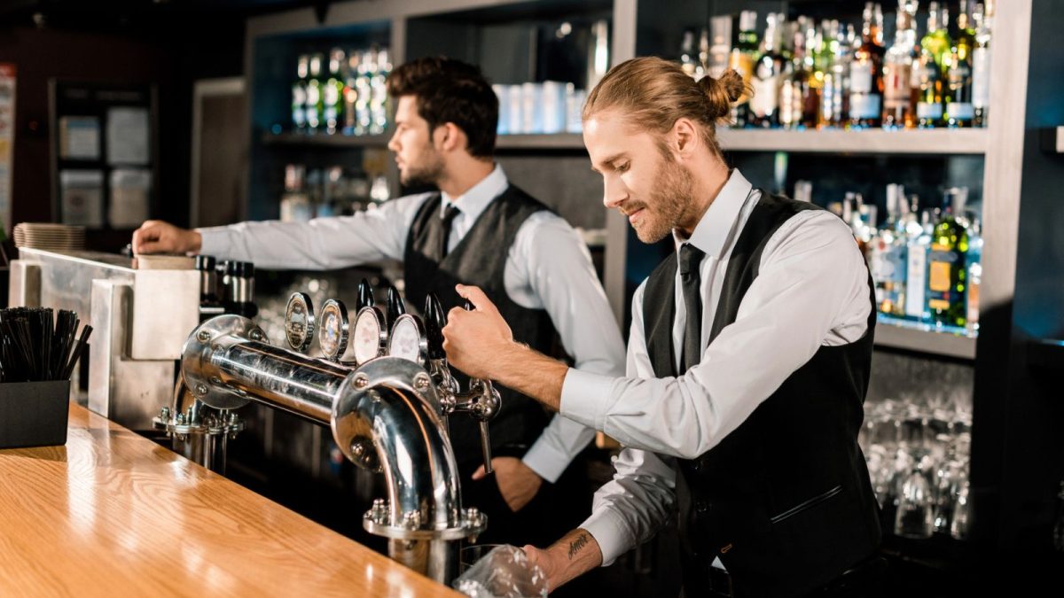 two bartenders making a drink