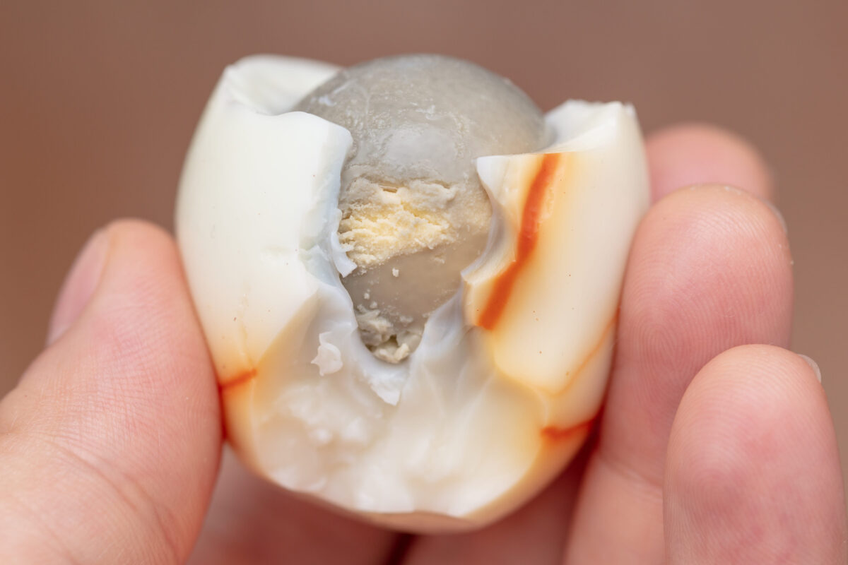 The 20 Most Disgusting Foods in the World 2 Boiled egg peeled and bitten in the hand .
