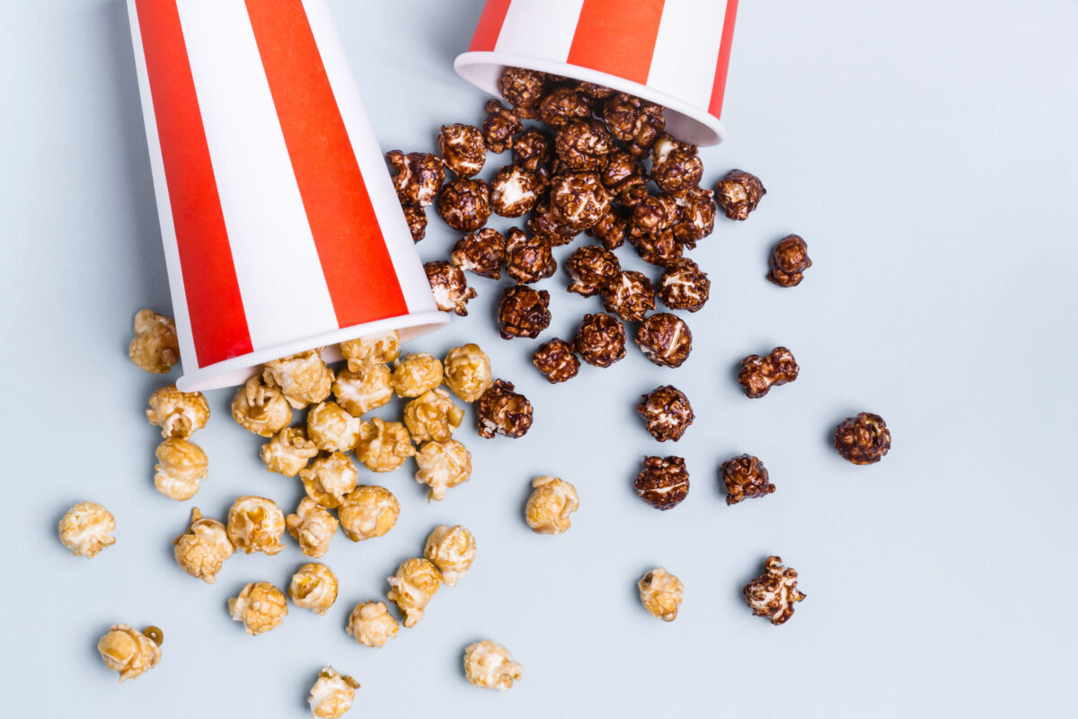 10 Shocking Things You Won’t Believe Are Really in Your Favorite Snacks 4 Sweet caramel chocolate popcorn in paper striped white red cup.