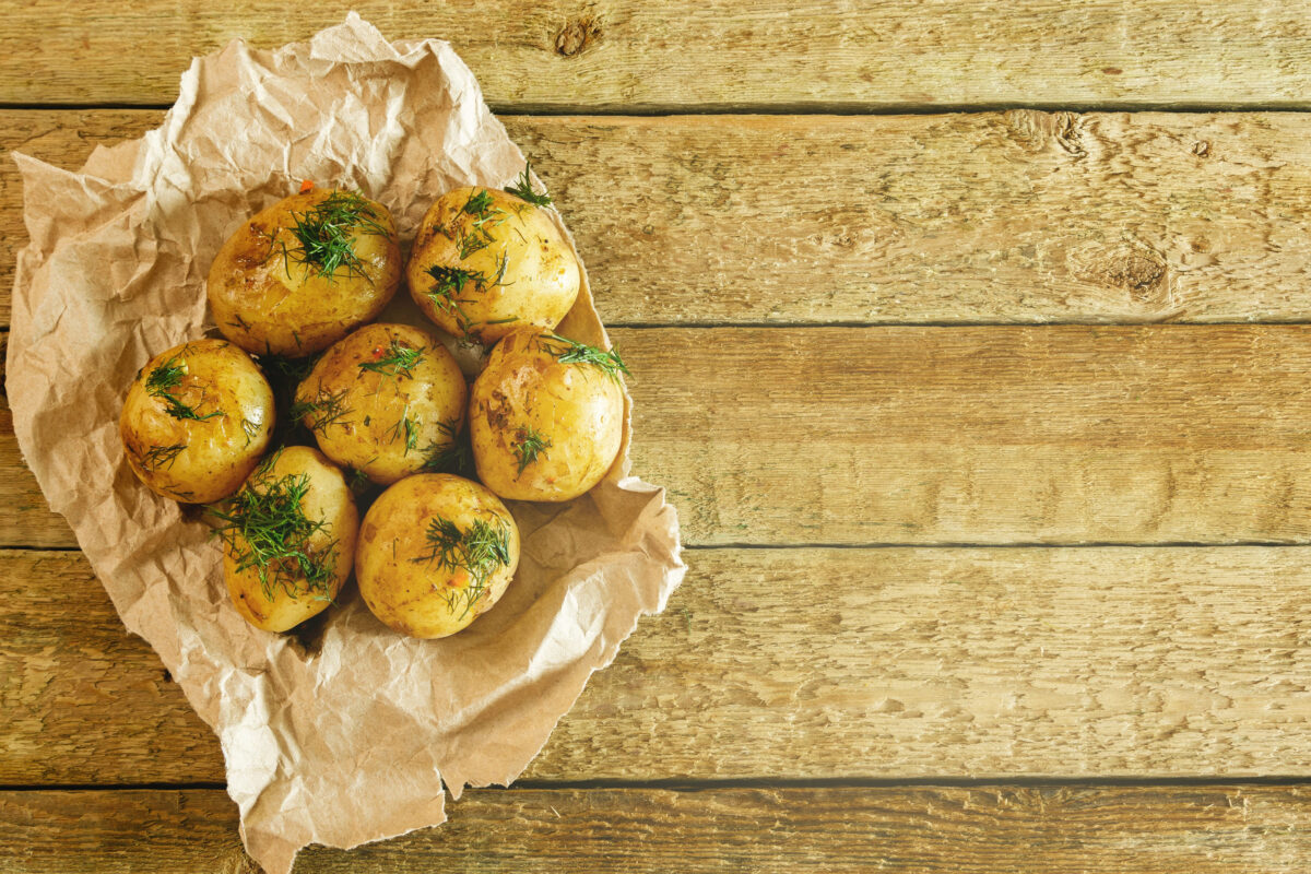 Foods You Should Never Cook in Aluminum Foil 2 Roasted potatoes with dill on wooden table