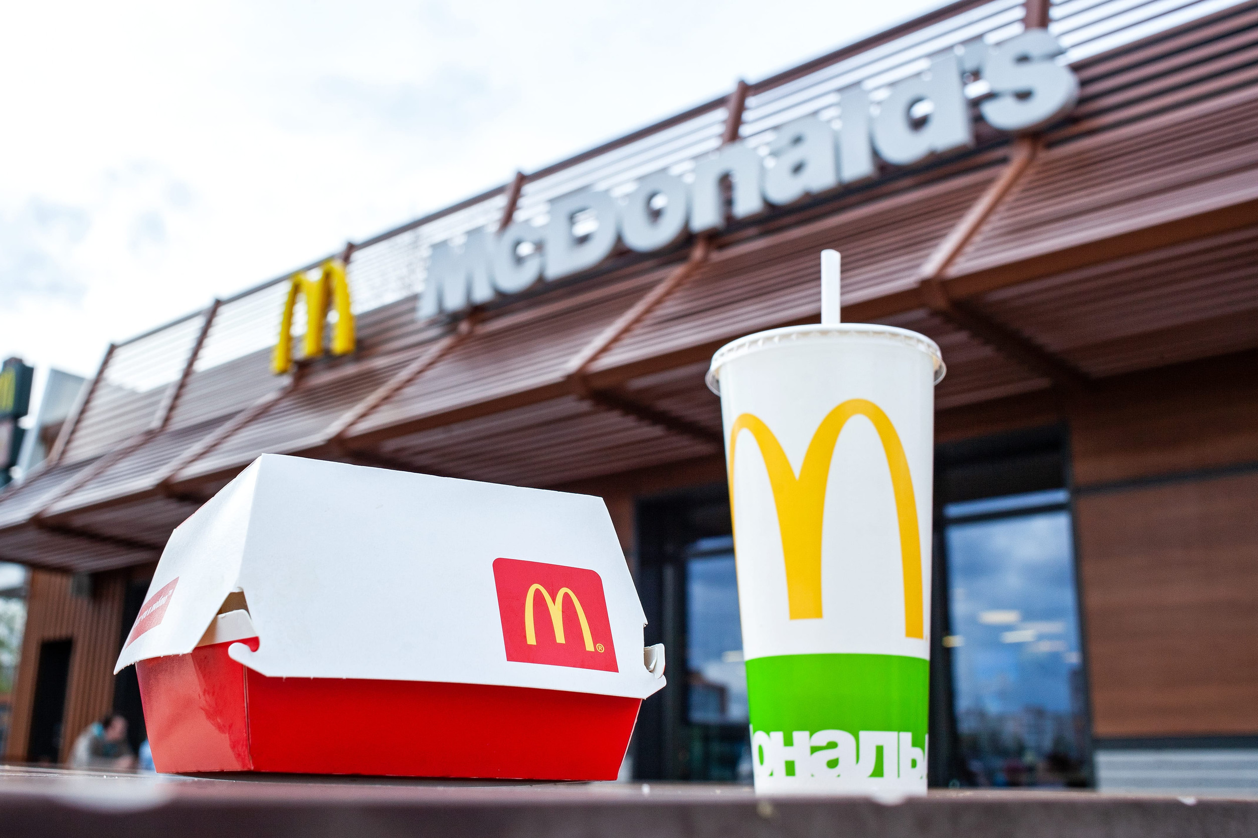 Minsk, Belarus, April 24, 2018: Big Mac and soft drink cup on table in McDonald's restaurant terrace