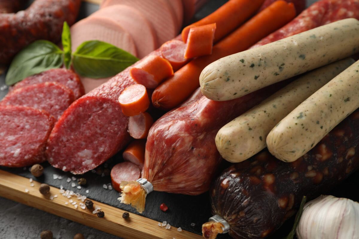 9 Foods That May Be Sabotaging Healthy Aging 2 Cutting board with sausage and spice, close up