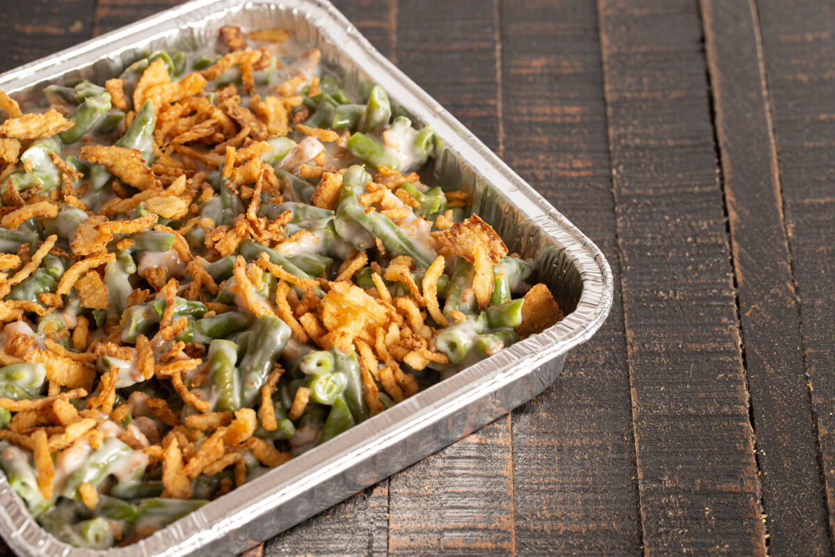 10 Once-Popular Foods People Stopped Eating and Why They Fell Out of Favor 3 Traditional Green Bean Casserole with Fried Onions on a Rustic Wooden Table