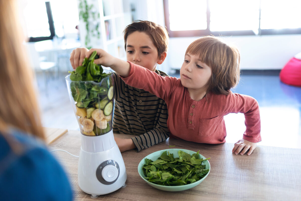 10 Everyday Foods That Could Be Slowly Damaging Your Child’s Kidneys 4 Shot of two boys helping his mother to prepare a detox juice with blender in the kitchen at home.
