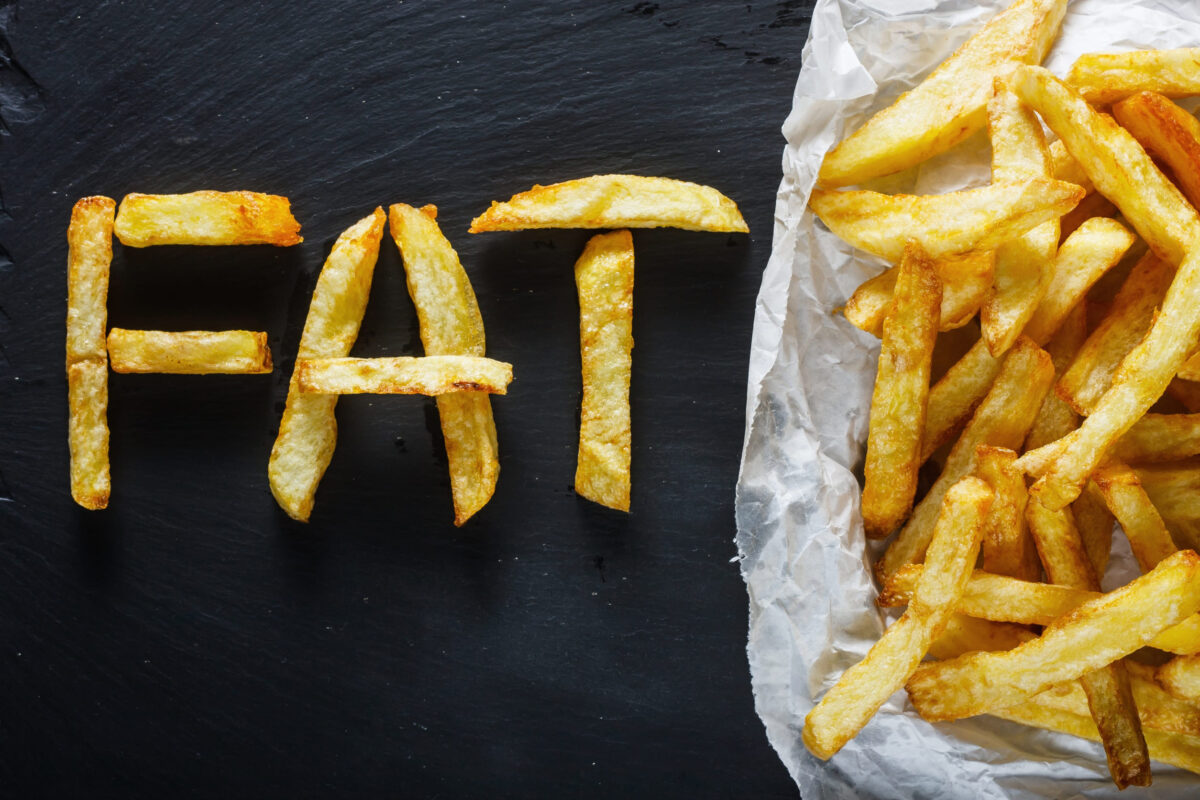 9 Ingredients in Processed Foods That You Should Avoid at All Costs 2 Unhealthy food concept - french fries on slate board