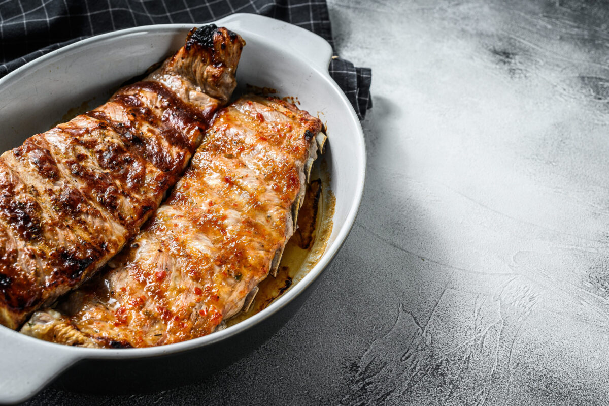 8 Short Rib Mistakes That Can Turn Dinner Into a Tough, Greasy Letdown 1 Spicy hot grilled pork spare ribs from BBQ served in a pan. Gray background. Top view. Copy space.