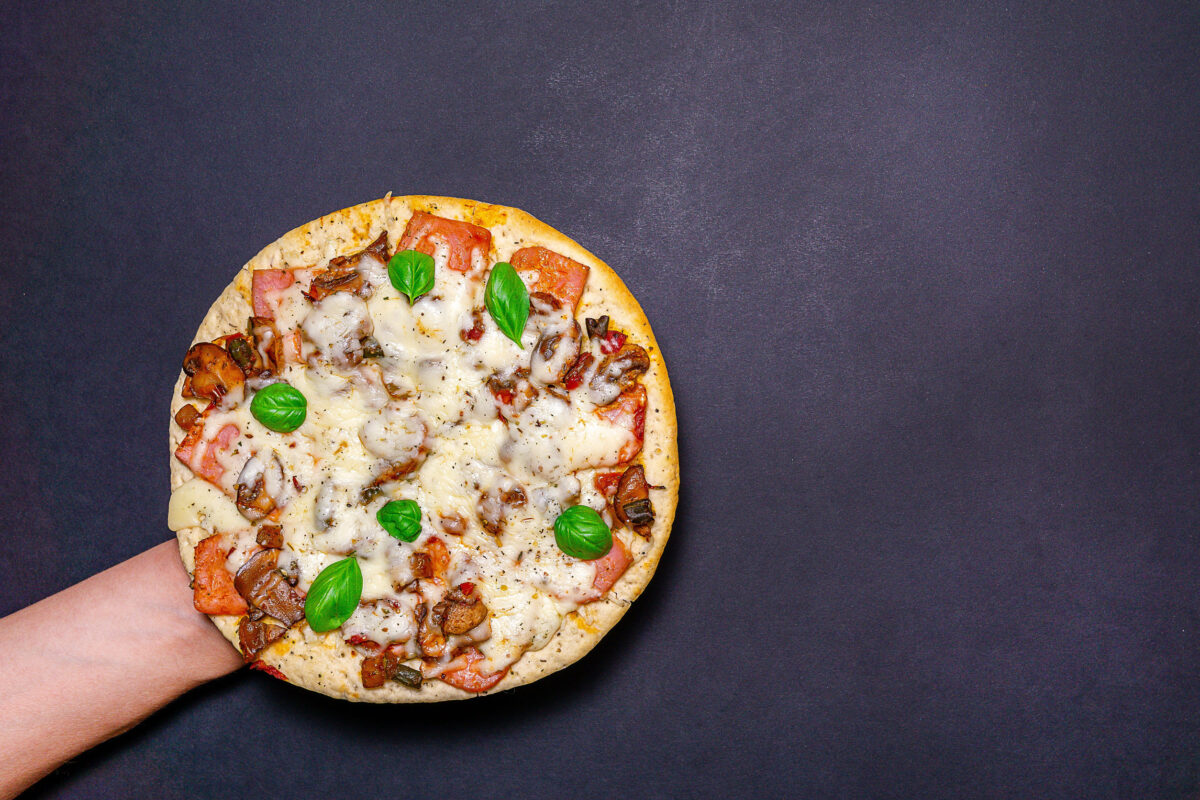 11 The Worst Pizza Toppings That Should Be Banned from Your Slice 2 pizza with mushrooms, Basil and cheese on a dark background. copy space. The view from the top. flat lay.