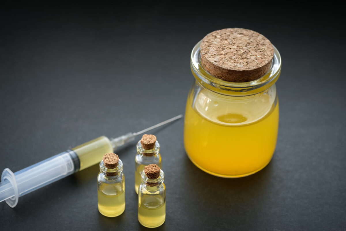 7 Banned Ingredients That Prove America’s Kitchen Had a Dark Past 1 Orange colored liquid in a bottle. Concept.