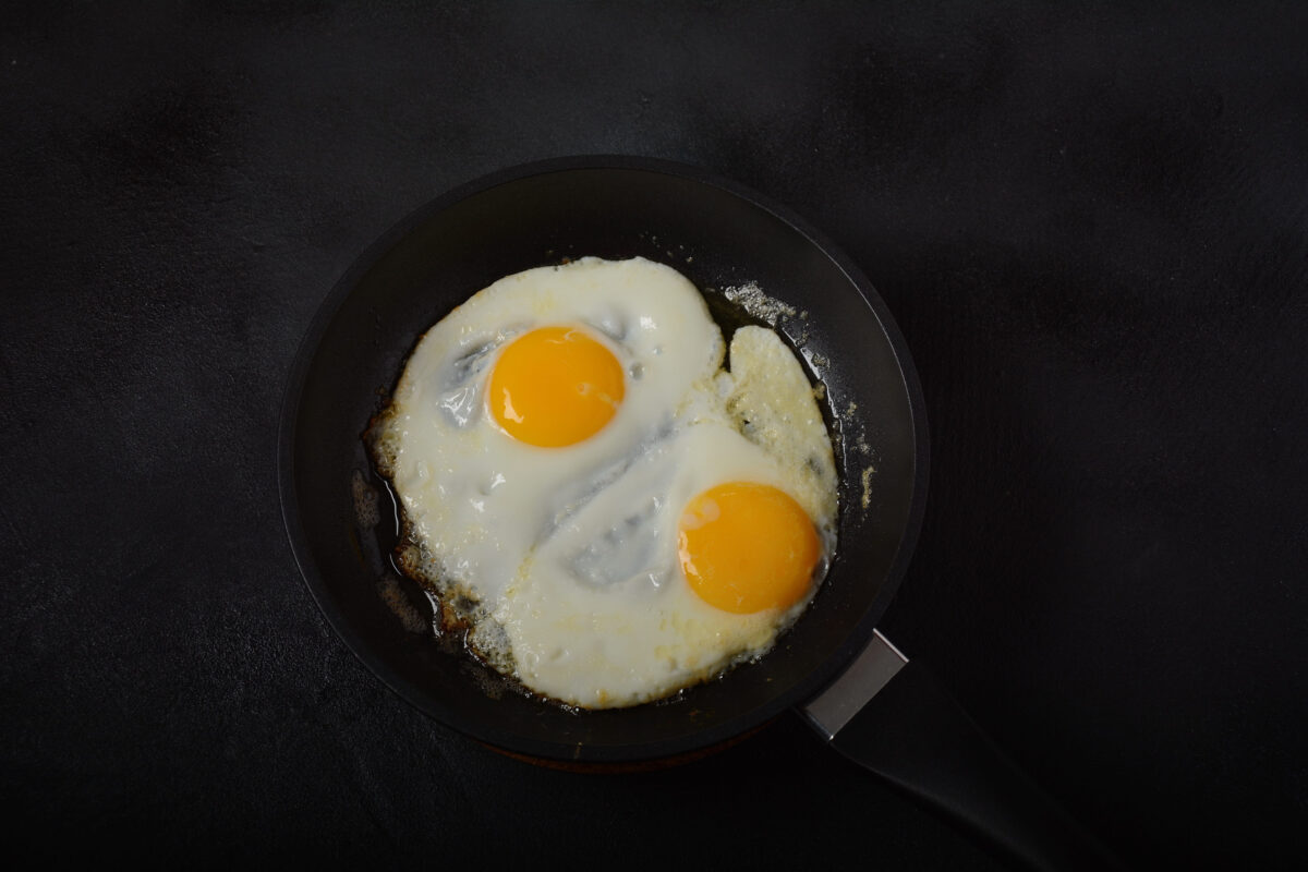The 10 Foods You Should Never Cook on Cast Iron 2 Two fried eggs in cast iron frying pan Healthy easy breakfast on a table. Fresh homemade meal on a frying pan. Traditional breakfast food. International cuisine food. Top view