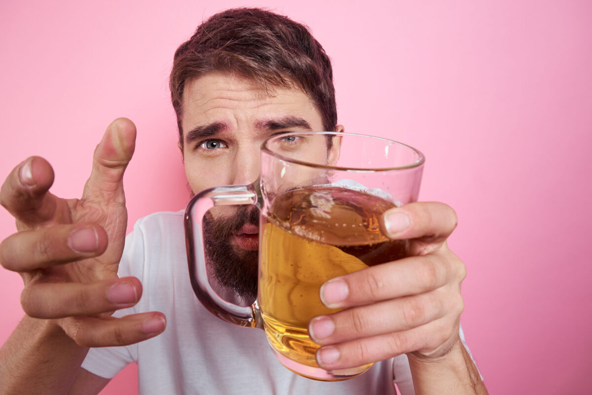 The 10 Worst Foods You Could Eat for Your Skin and What You Should Choose Instead 3 Drunk man with a large mug of beer On a pink background and a white T-shirt relaxed view of a thick beard